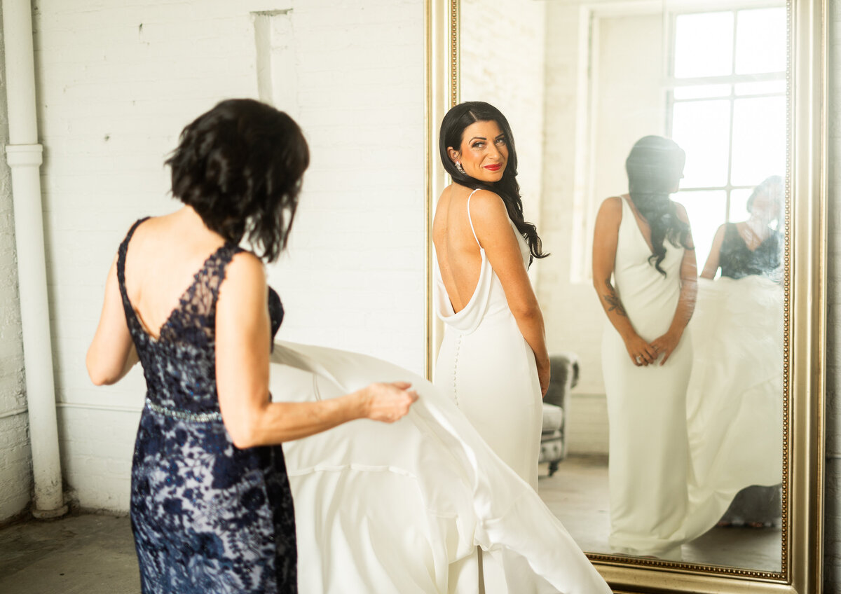 mother helping bride get her wedding dress on at The Madison in Cleveland 