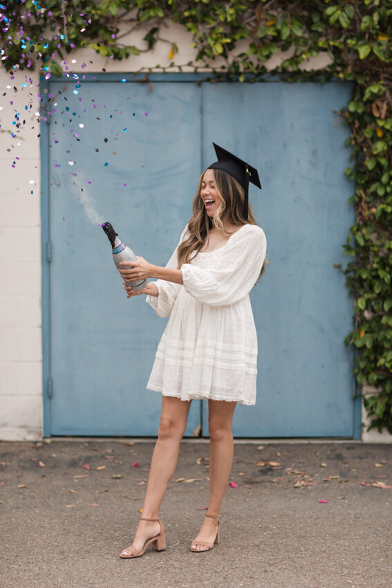 Senior girl popping confetti