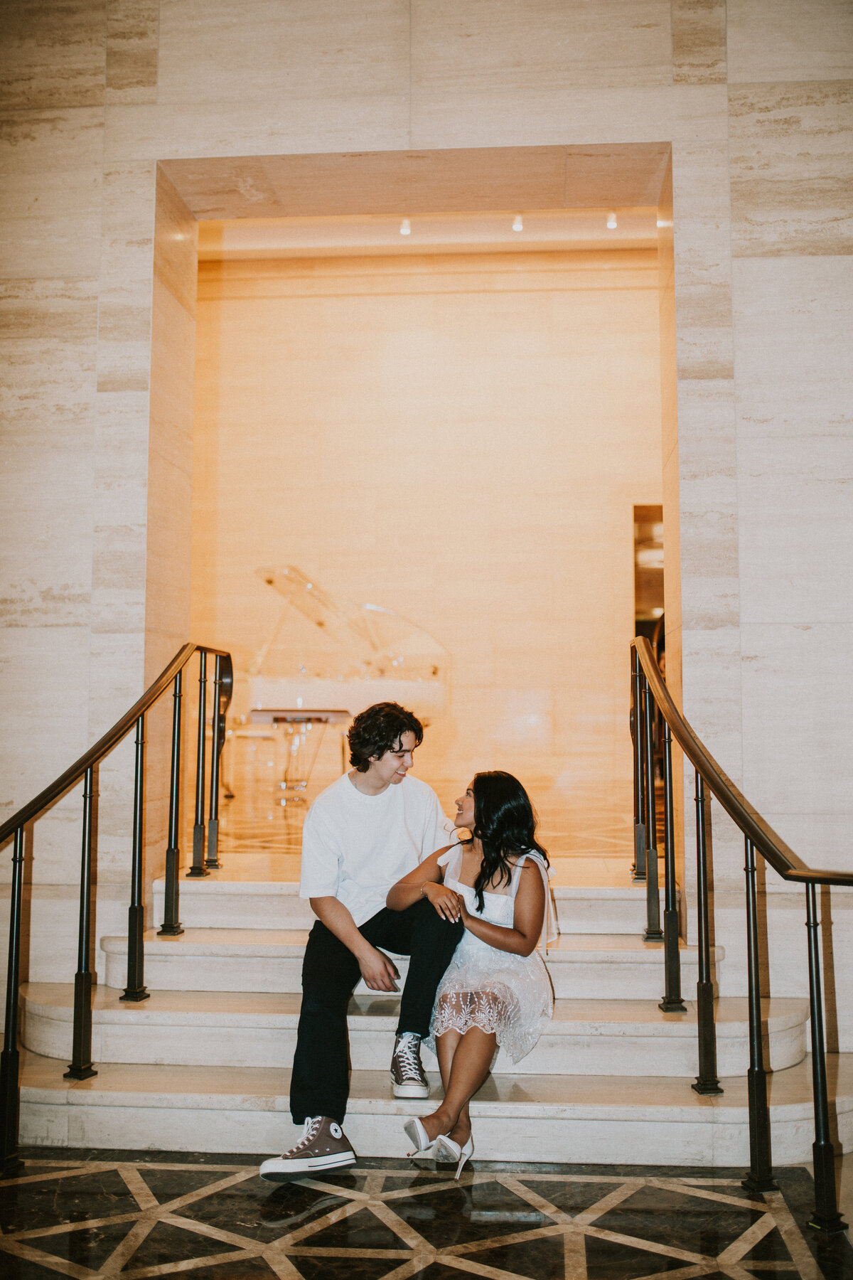 couple sitting on stairs during engagement session