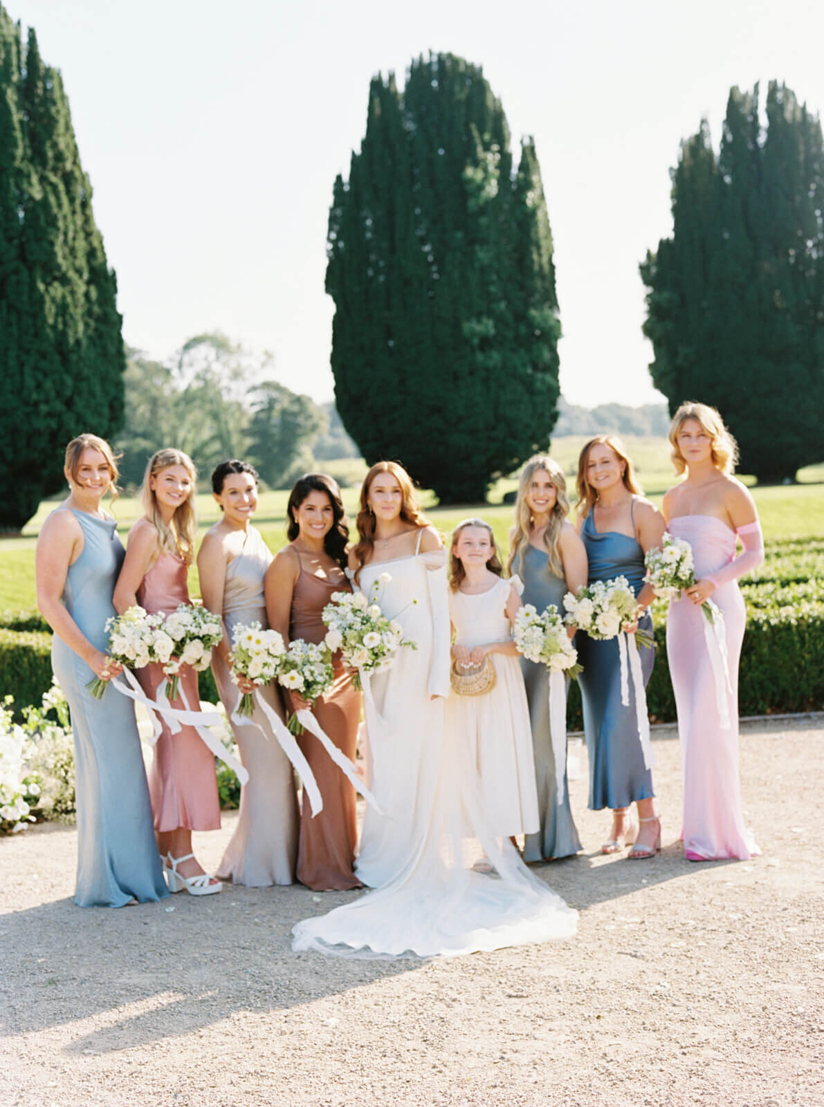 Photo of the bride and her brides maids together in the gardens of castlemartyr after their wedding ceremony