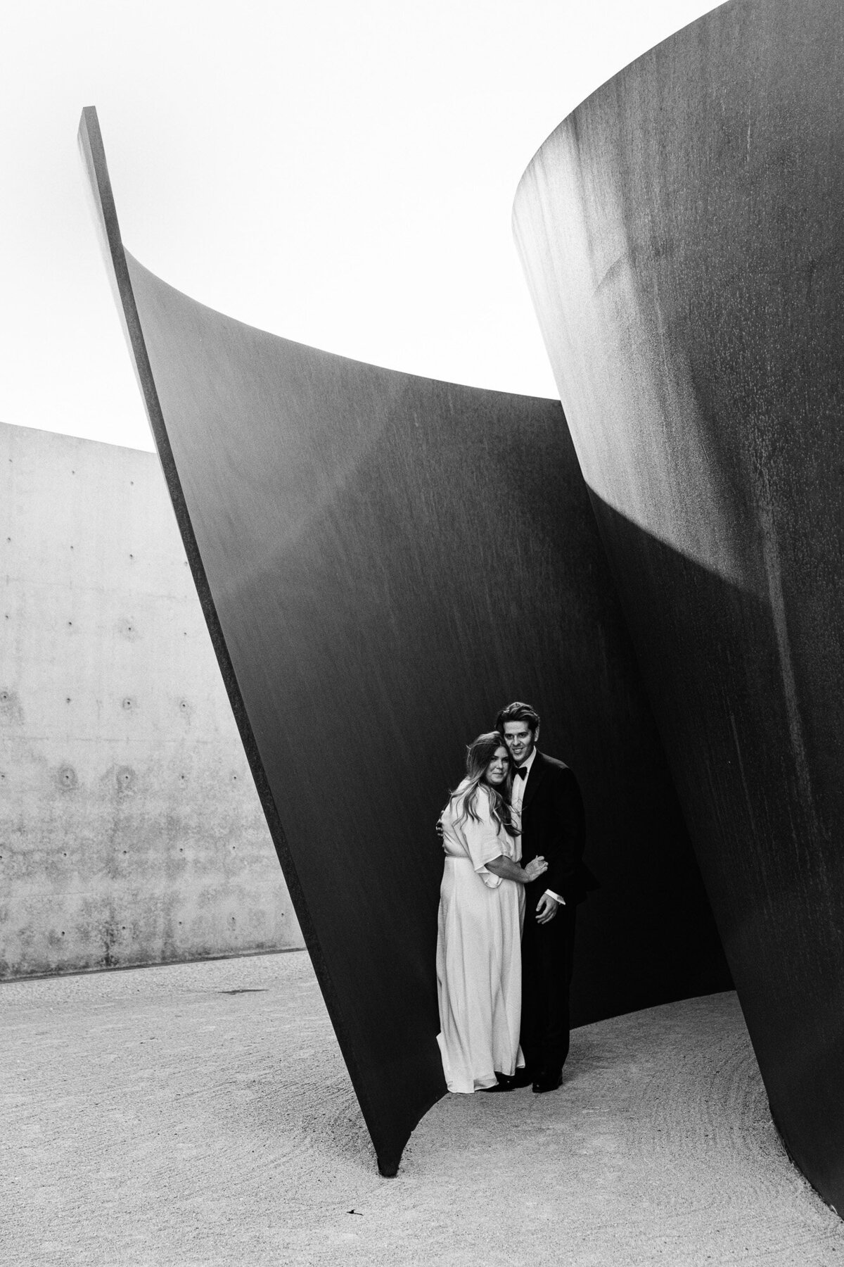 A couple poses by "joe" designed by sculptor Richard Serra.
