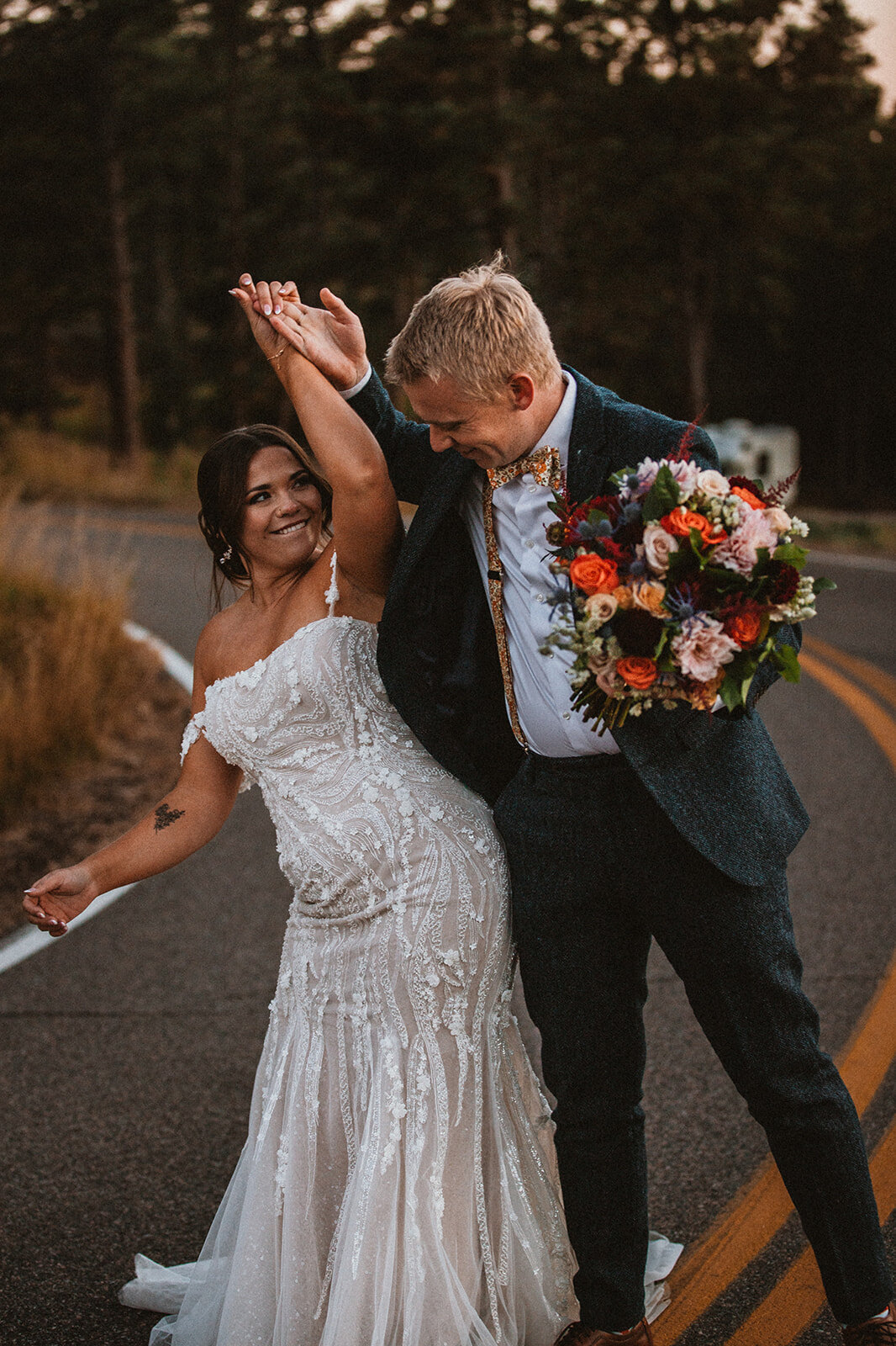 bride and groom bump hips while walking 