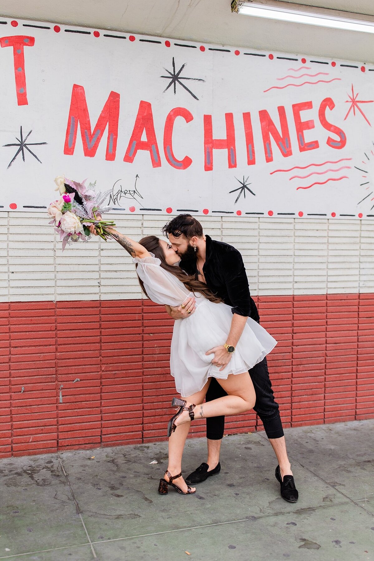 groom dips bride on the street