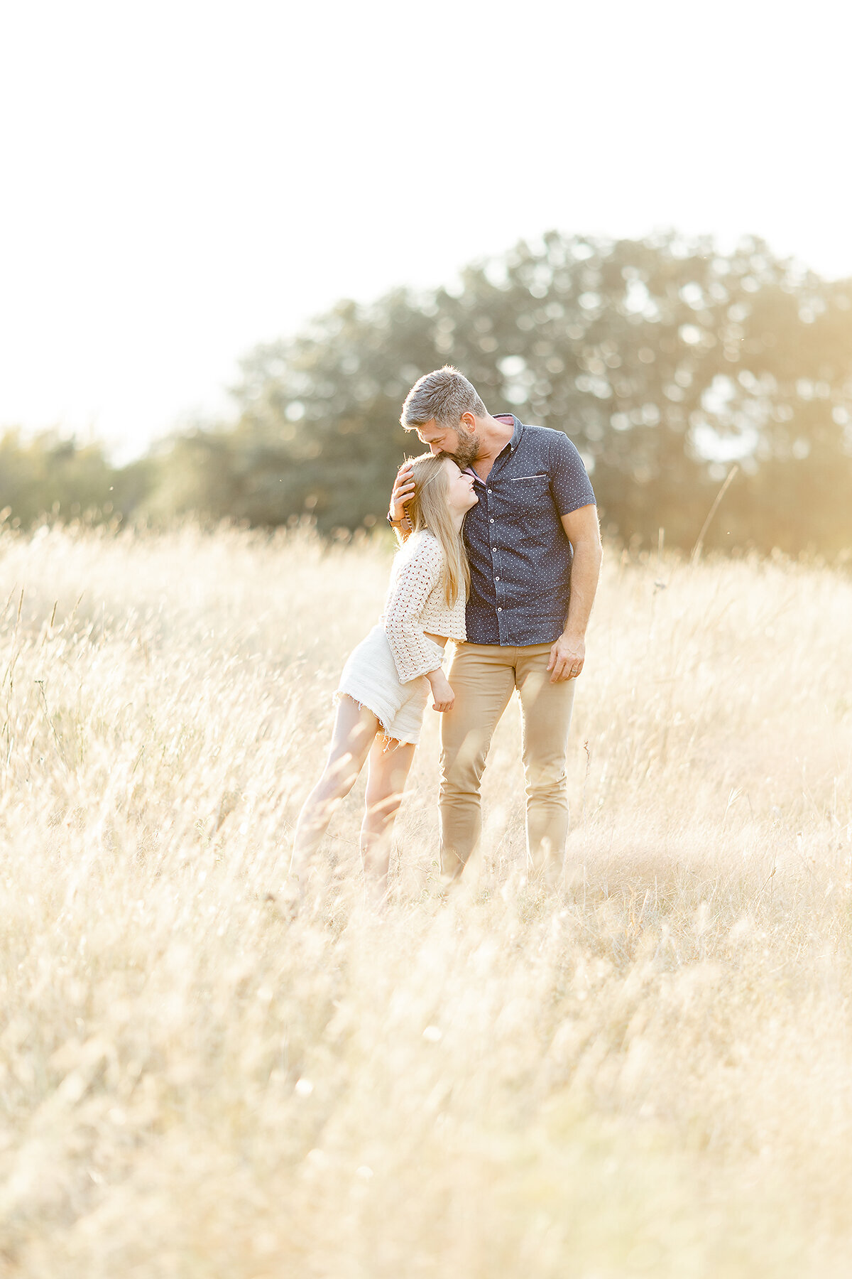 A father and daughter photo in the middle of a field for their family photos.