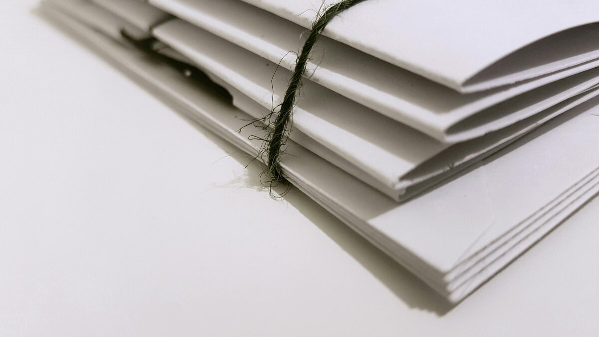 Stack of papers wrapped in a brown thread