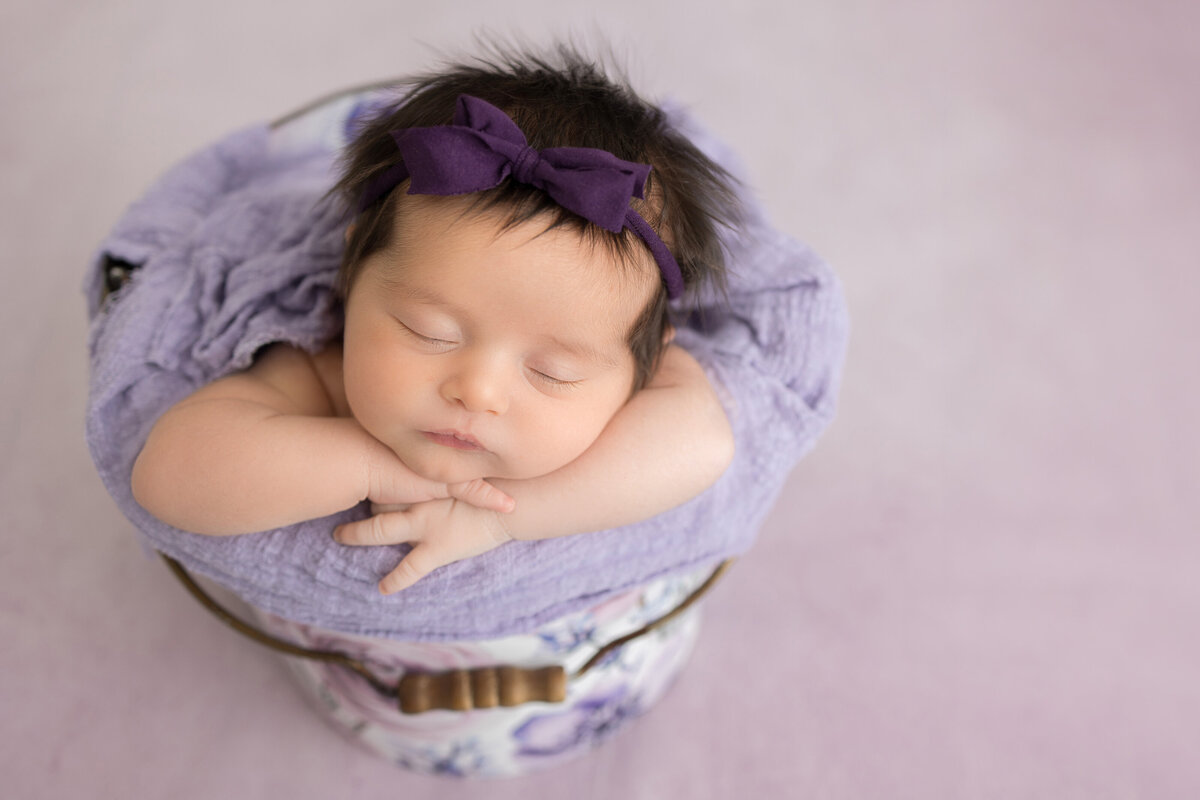 A purple newborn session photographed By South Jersey Newborn Photographer, Susan Hennessey Photography.