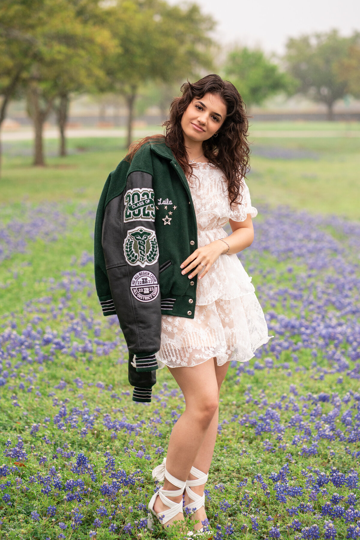 High School Senior in Austin Texas with Letterman Jacket in Bluebonnets