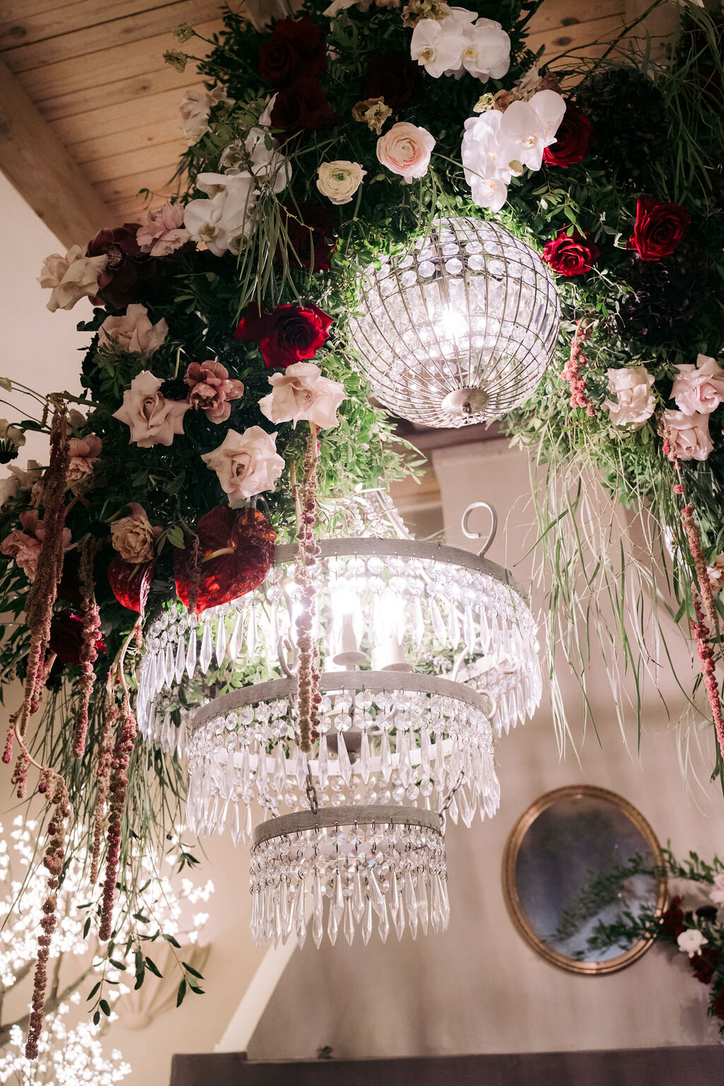 Luxurious chandeliers and opulent flowers for wedding ceremony