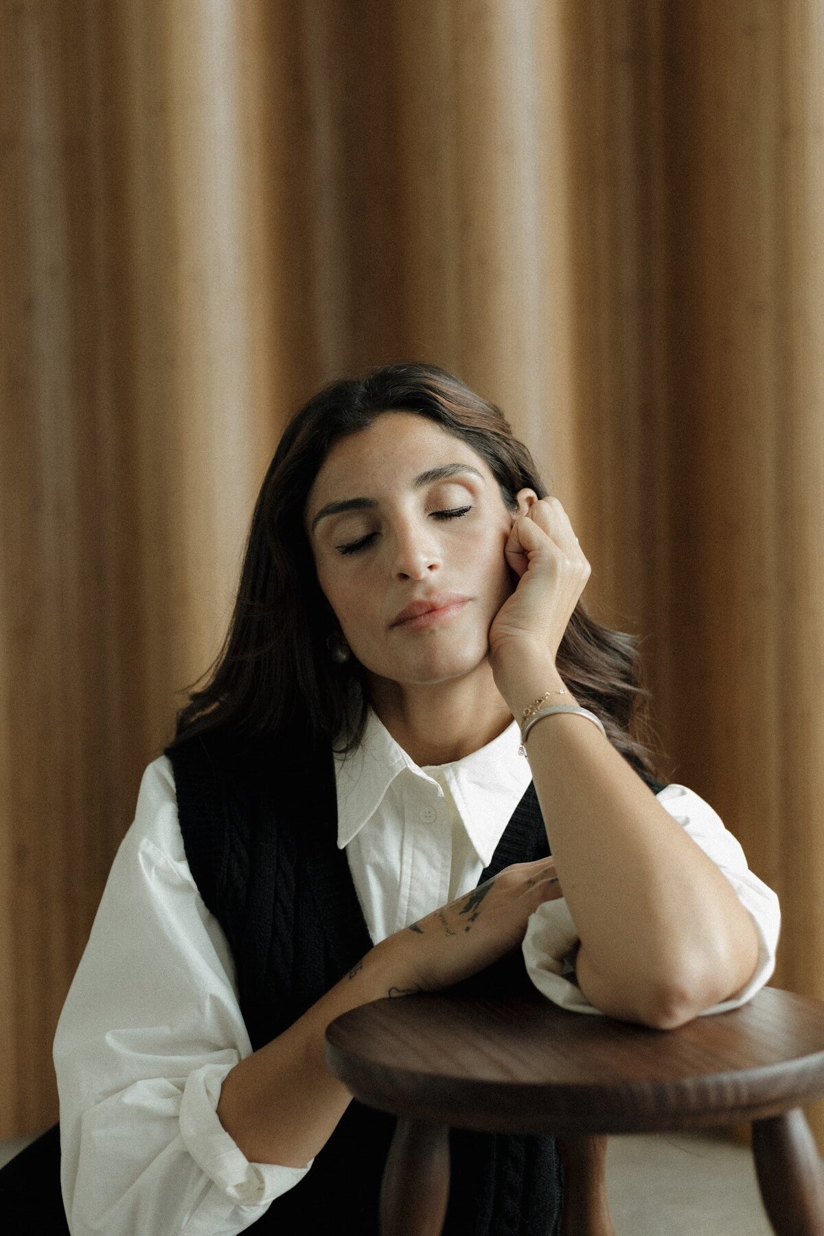 Jiordana with eyes closed, resting her head on her hand
