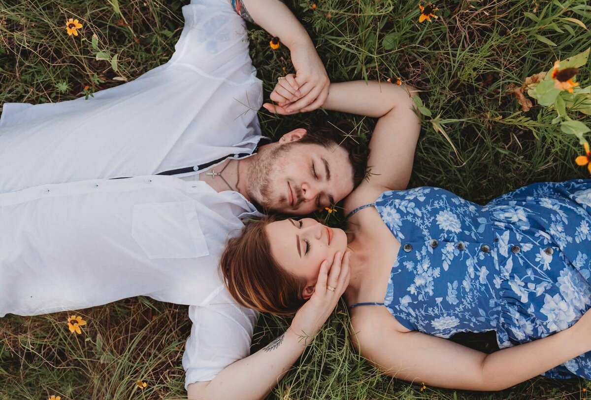 happy-couple-laying-in-grass