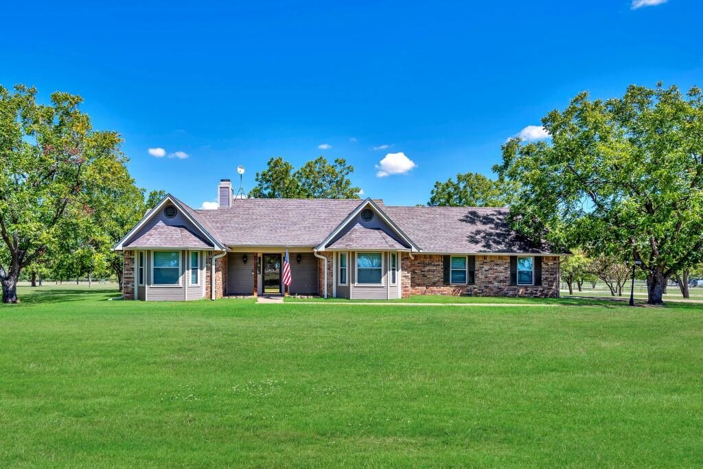 Front view of this three-bedroom, two-bathroom vacation rental home with hot tub, firepit, and free WiFi just minutes from Lake Waco.