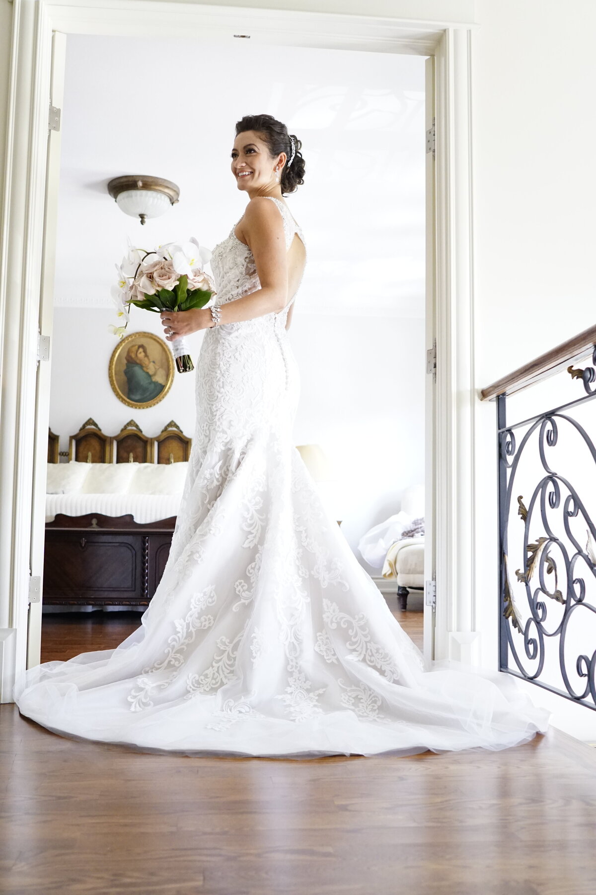 A beautiful bride poses in her wedding dress, highlighting the elegance and intricate details of her attire. This image captures the grace and beauty of the bride, showcasing the timeless and sophisticated essence of our bridal portrait photography.