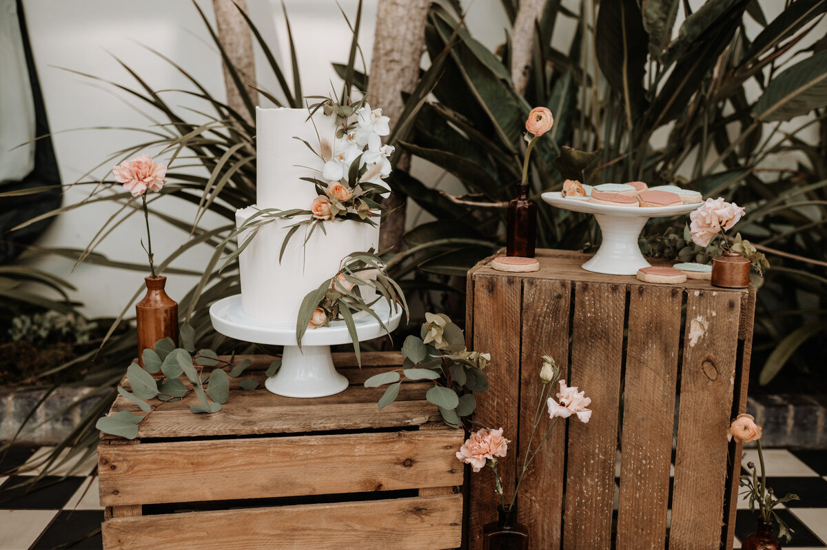 Botanical wedding cake with biscuits on dessert table