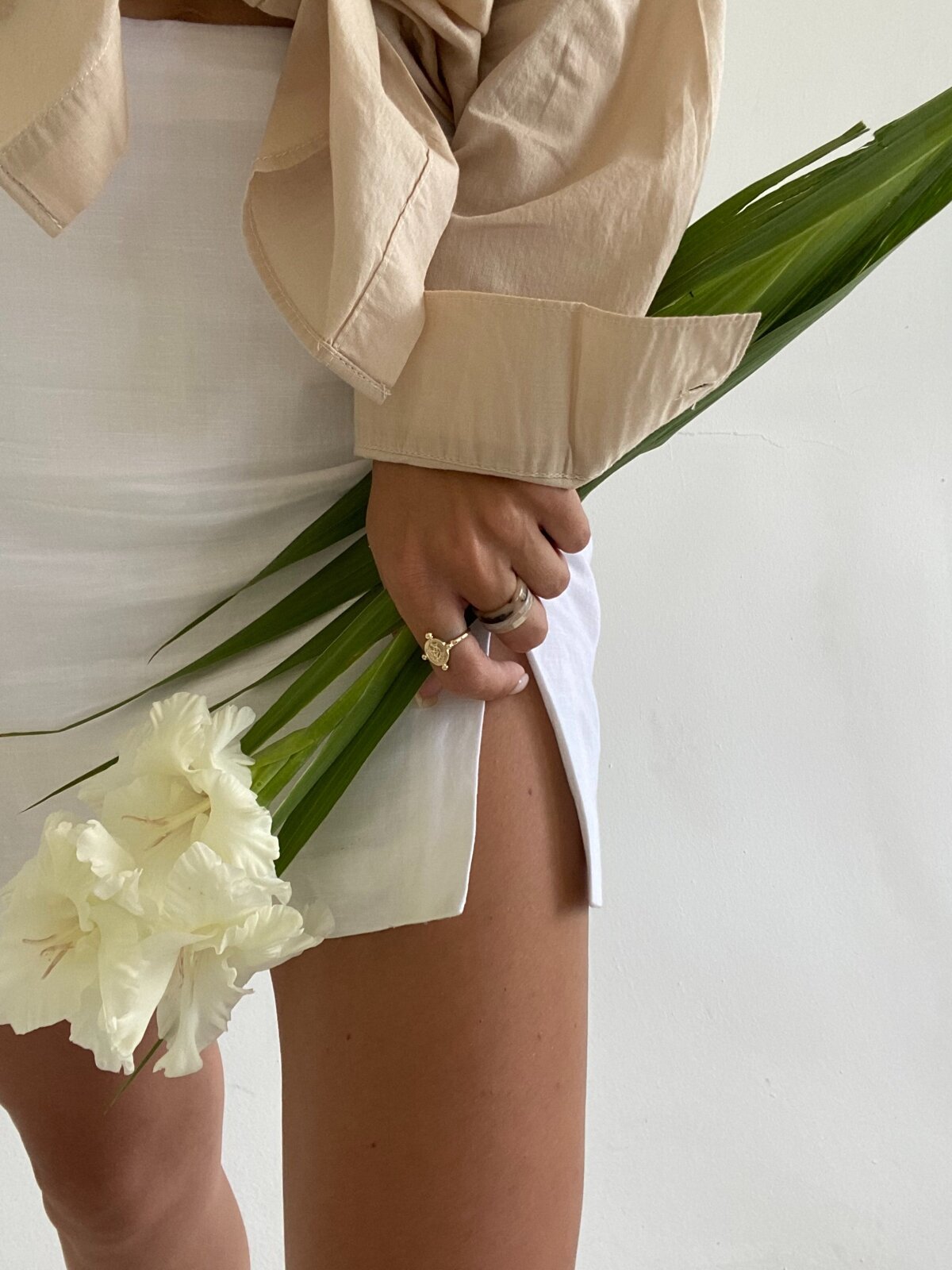 Woman holding flowers in white skirt