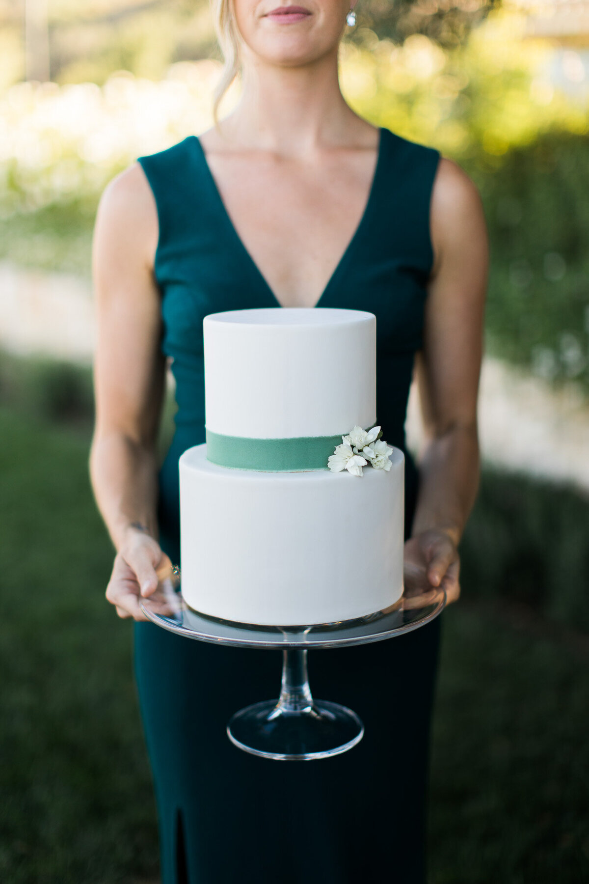Bride holding a black, white, and teal for modern luxury destination wedding