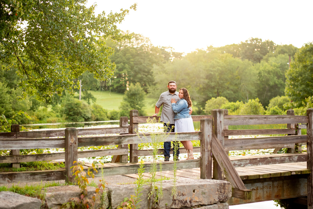 "Experience the fusion of rustic charm and cowboy boots on a picturesque bridge at Southford Falls in Connecticut. This engagement photo captures the essence of a unique and heartfelt love story