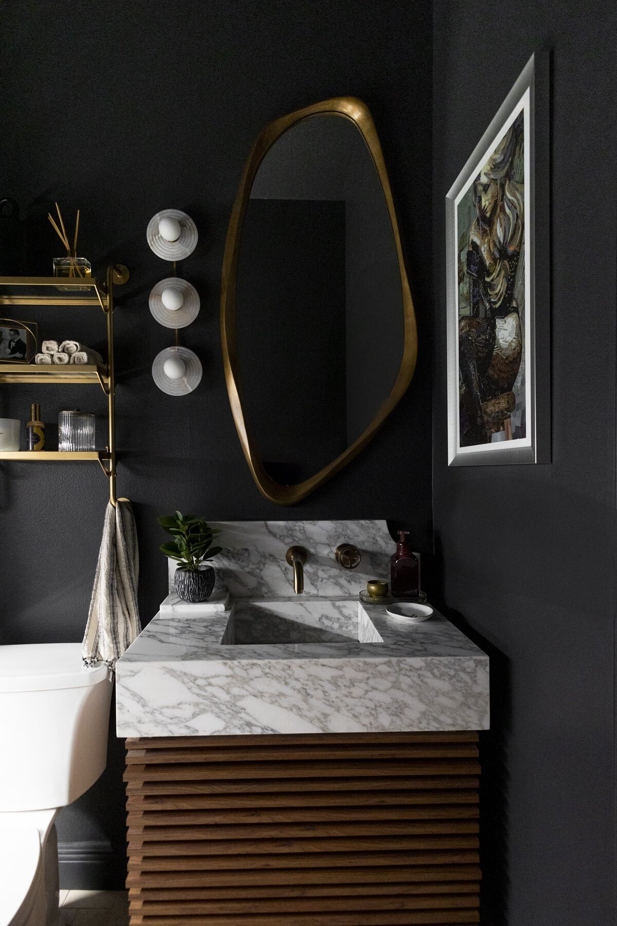 dewine design interiors moody guest bathroom with wooen vanity with marble sink top