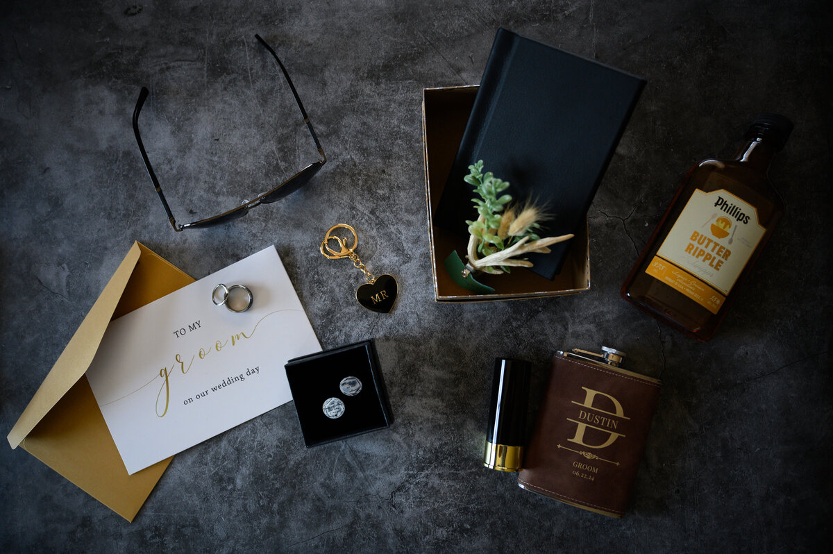 Grooms wedding day accessories laid out artistically for detail photos 