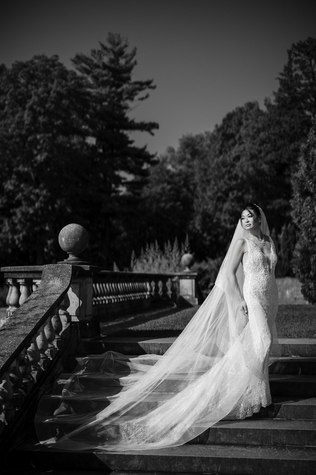 A bride poses on steps at a destination wedding in Vermont
