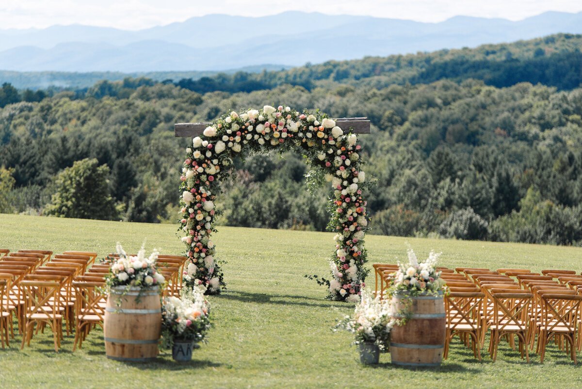 clayton floral archway with blue mountains in distance on green field in new england