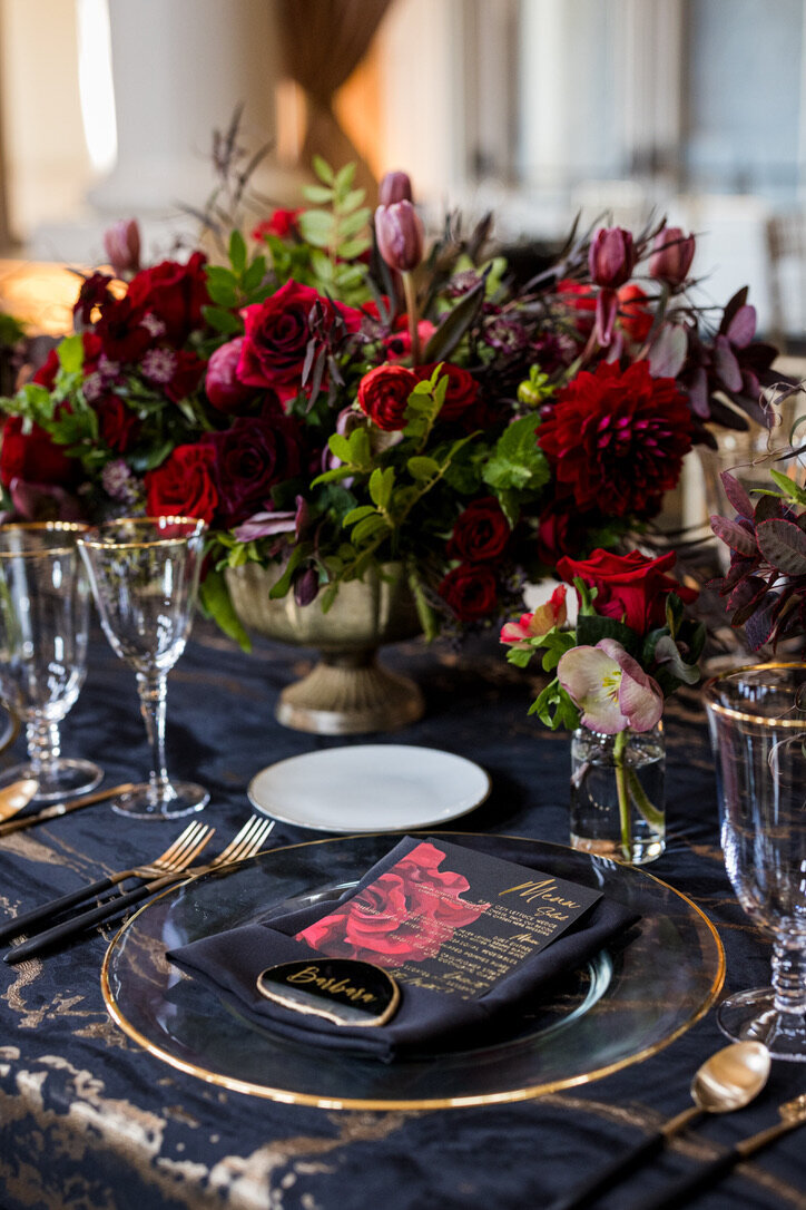 oblong arrangements, candle light, gold footed dishes, tea lights, black and white linens, gold rimmed glassware, black matte flatware