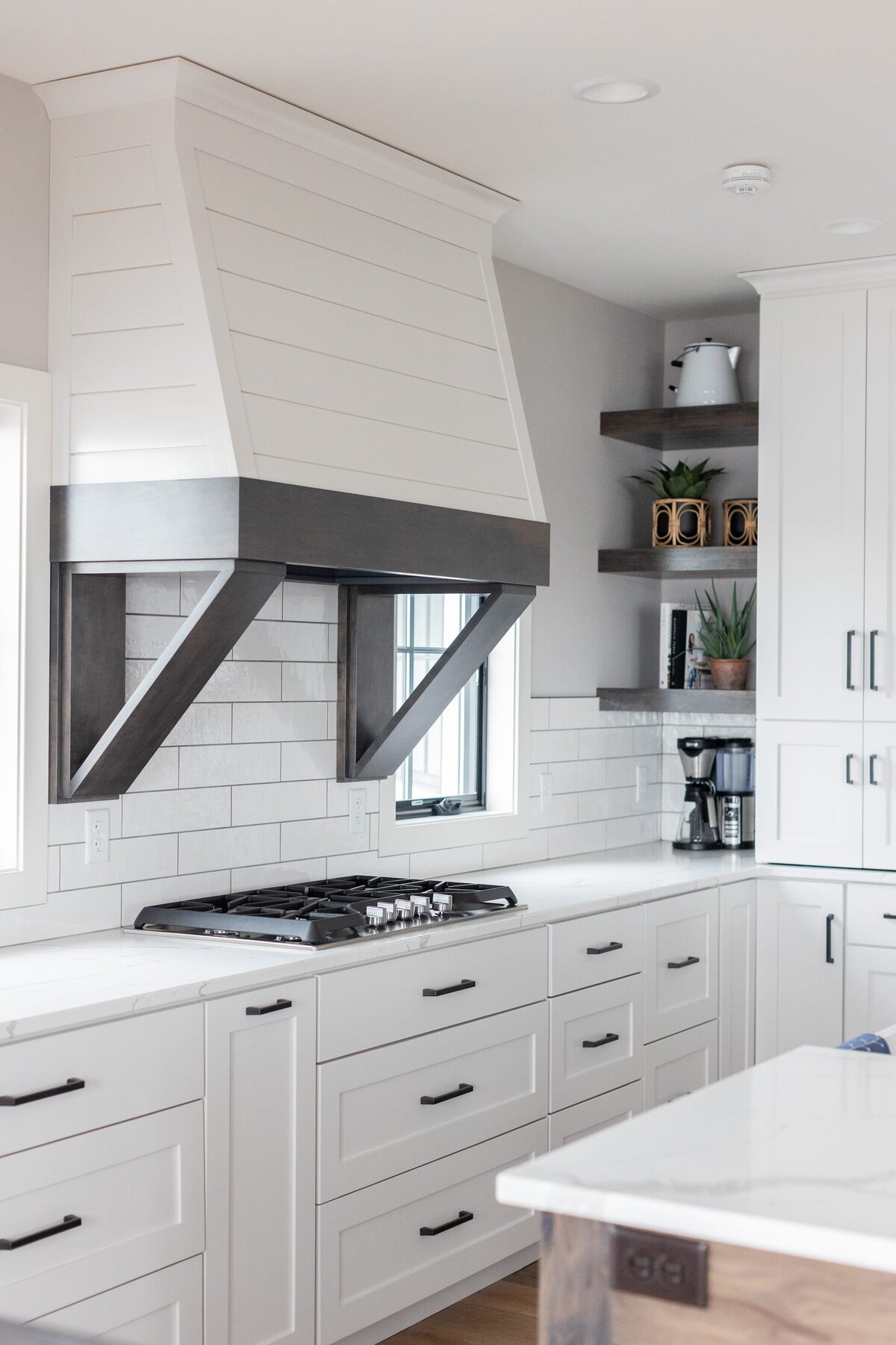 michele rosenboom design modern farmhouse white vent hood over oven with white kitchen cabinets