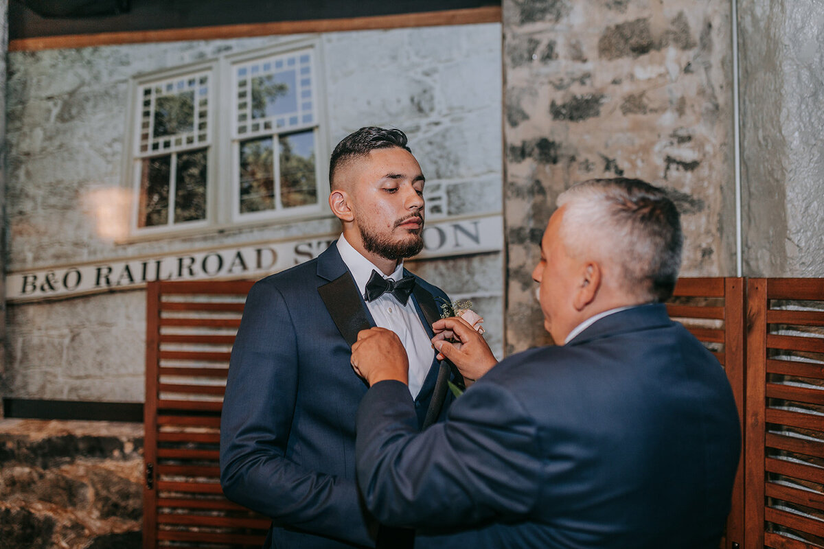 Dad fixing his sons suite for the wedding