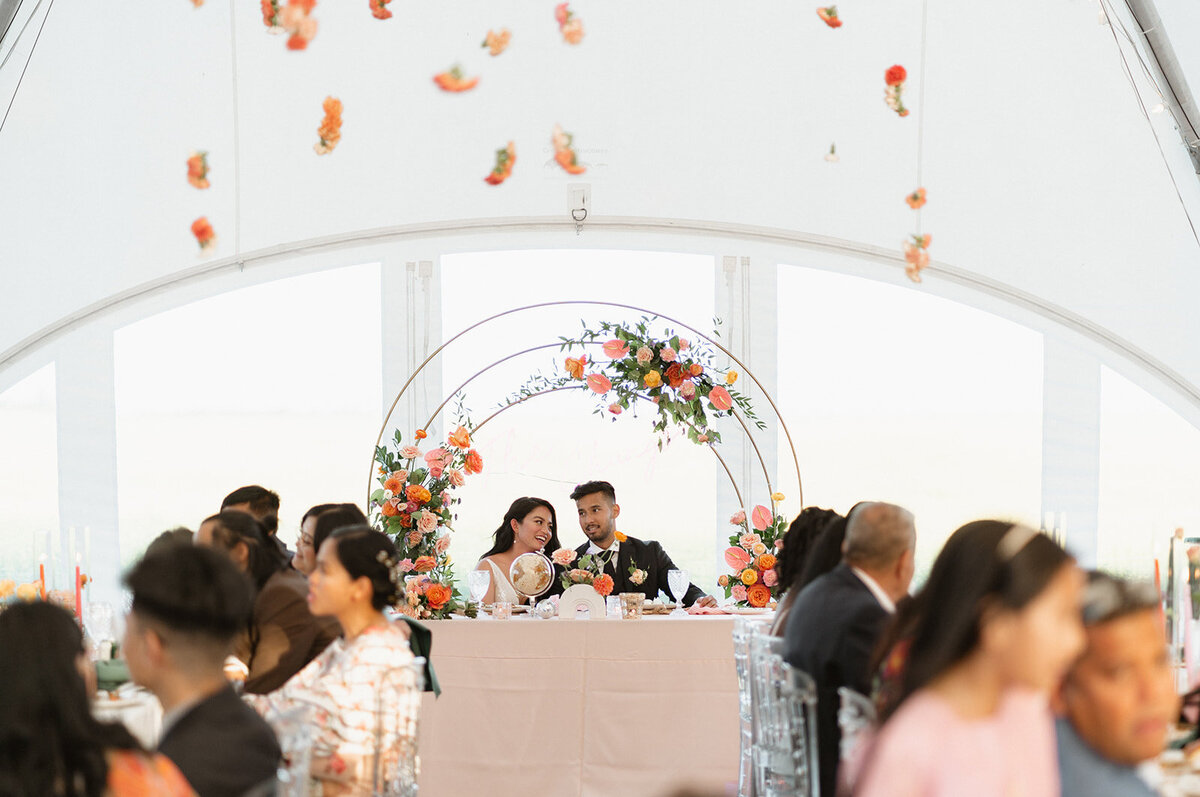 Summer tent wedding Inspiration - River's Edge Alberta - colourful high-end wedding designed by Rebekah Brontë Designs with a hanging floral installation and disco balls