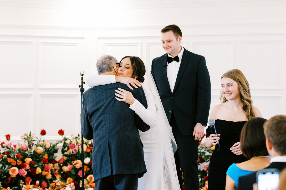 The moment at the wedding ceremony in St. Paul College Club when Bride is hugging her grandfather with tears.