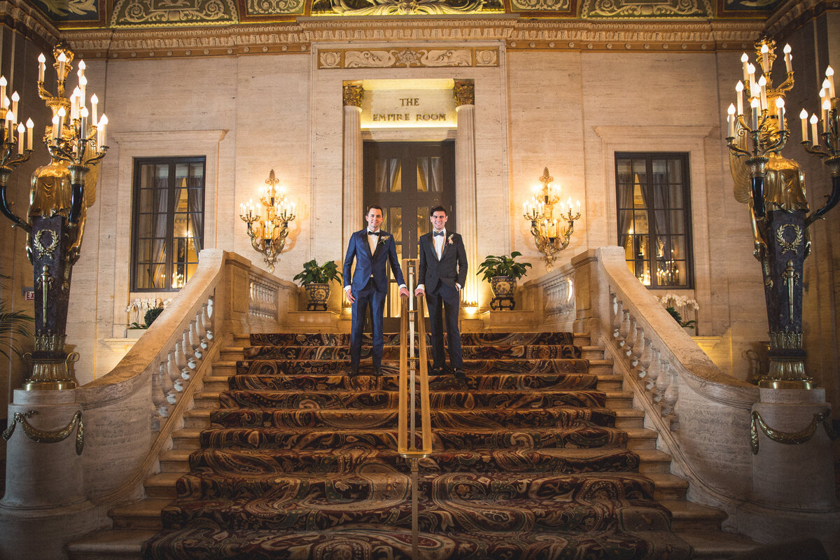 Two dashing grooms on the steps of the Palmer House in Chicago, IL