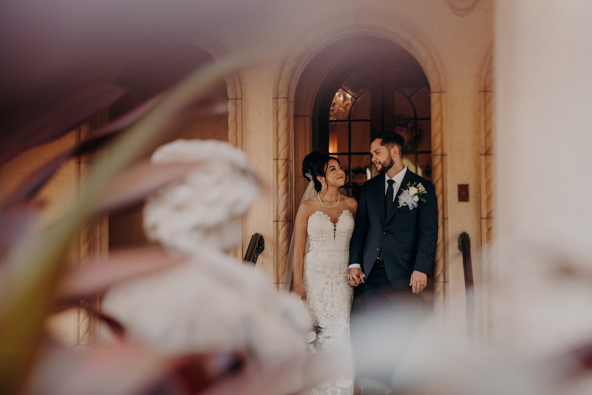 Bride and groom wedding portraits under the arches at Powel Crosley Estate in Sarasota Florida. 