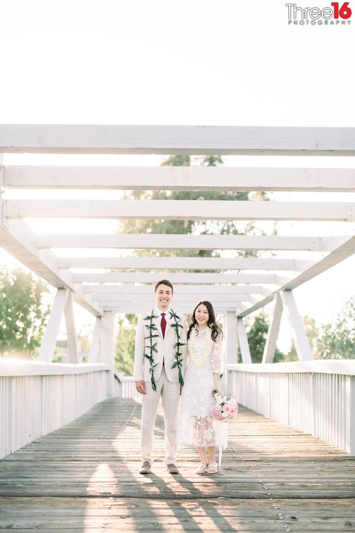 Bride and Groom pose together on a bridge at the Mike Ward Community Park in Irvine