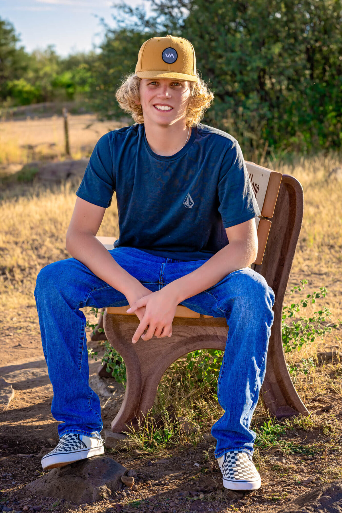 Boy poses on bench for Prescott senior photography session
