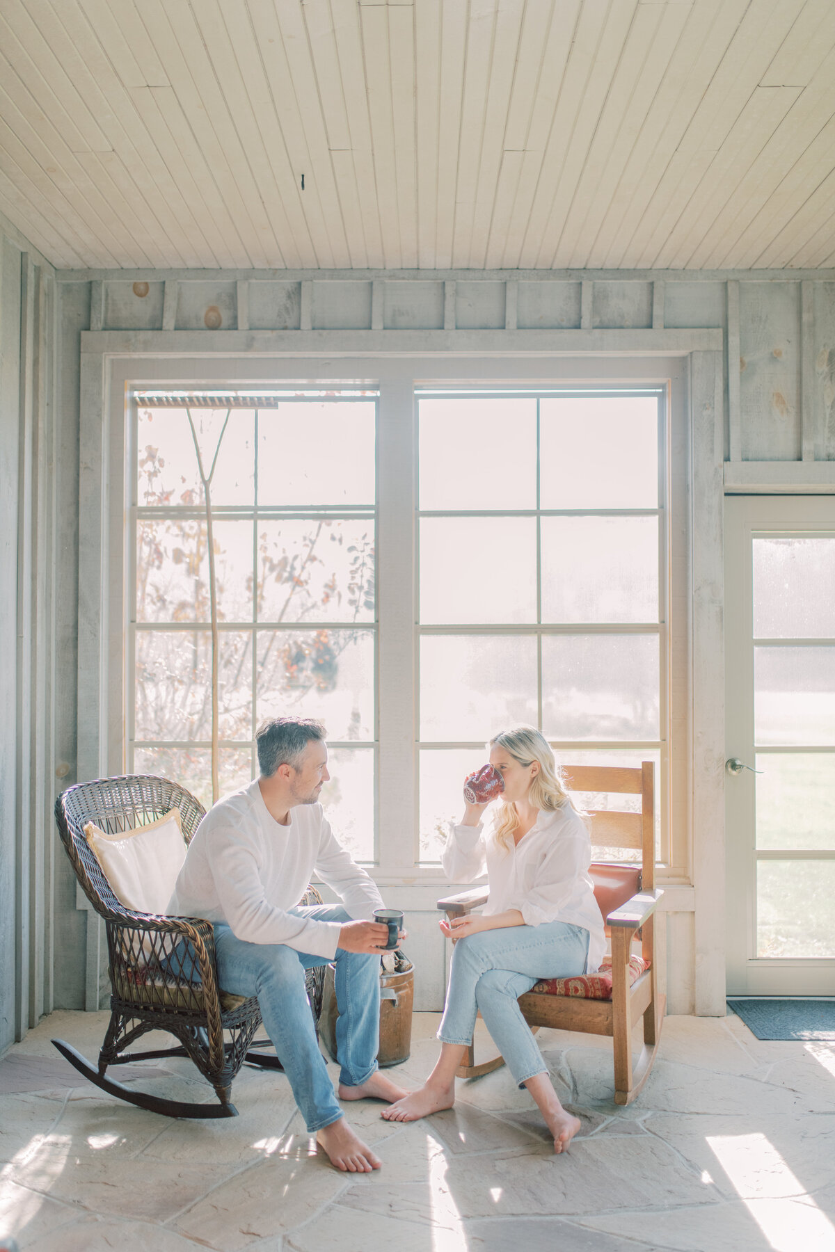 A quiet moment of reflection as she gazes out the window at Elora ON, a cup of coffee warming her hands, wrapped in the embrace of soft morning light
