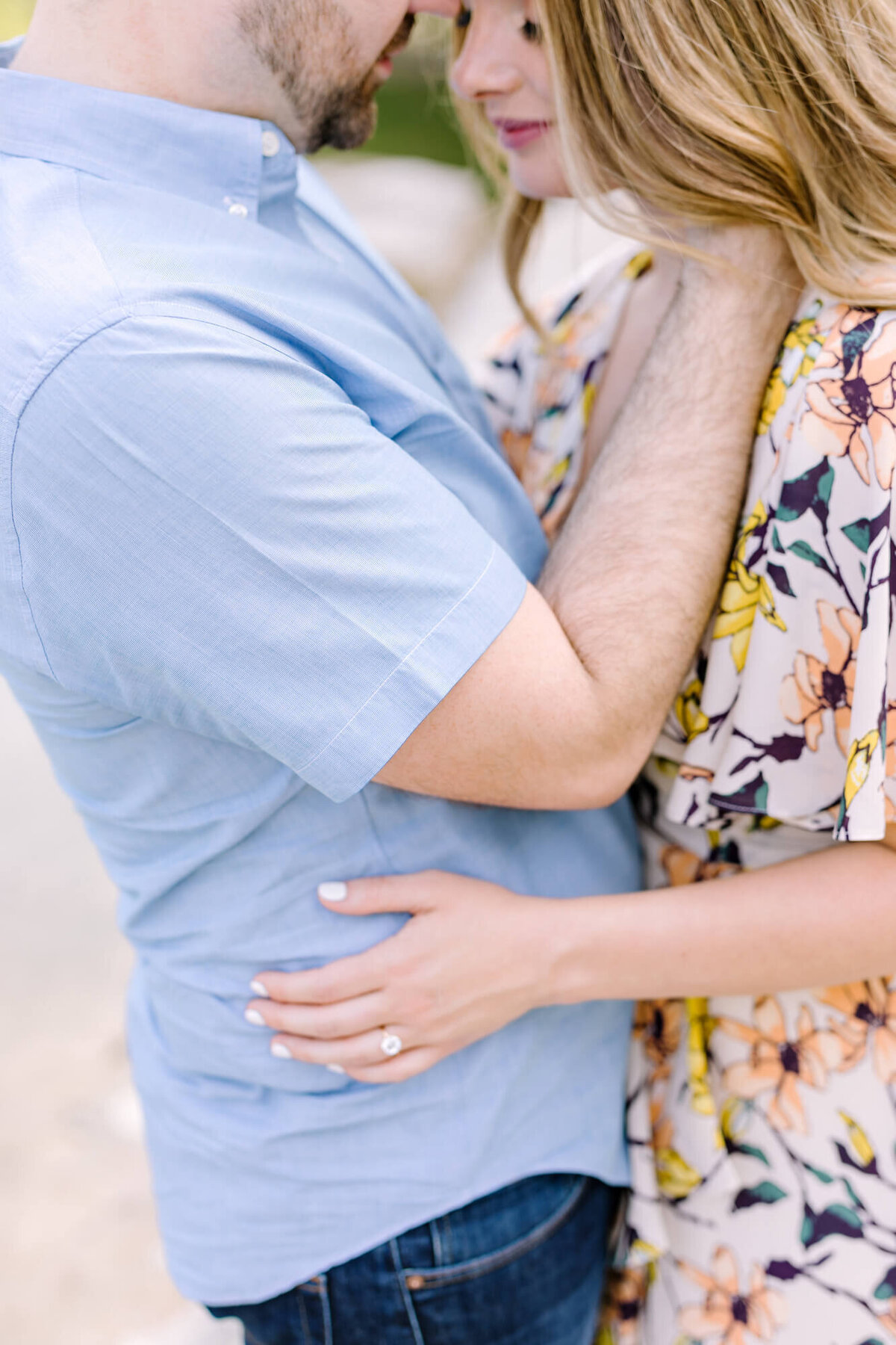 Couple holding hands and embracing at their Austin engagement session