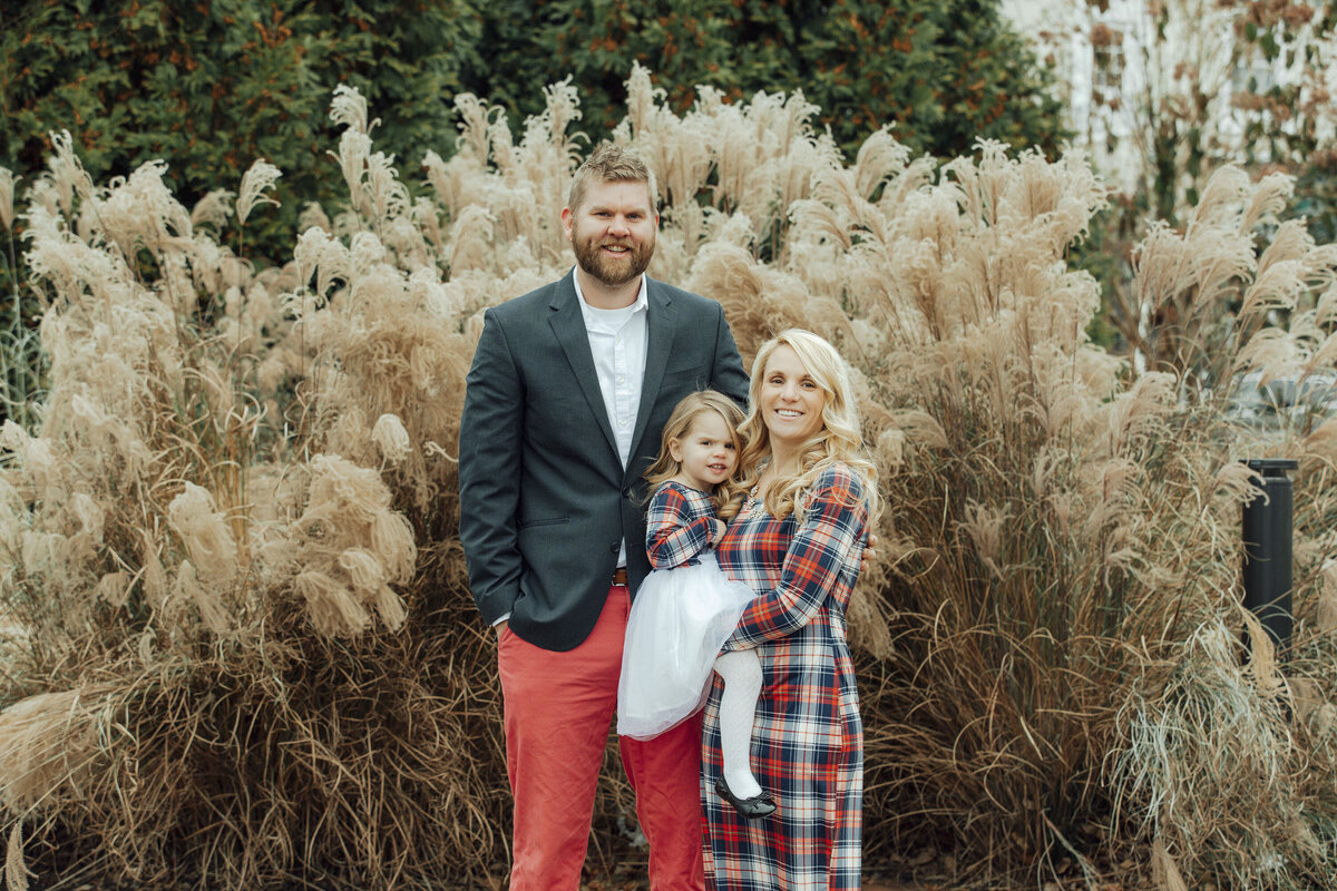 Family Photographer | Family posing together in a snowy park during a winter portrait session | New Hope, Pennsylvania