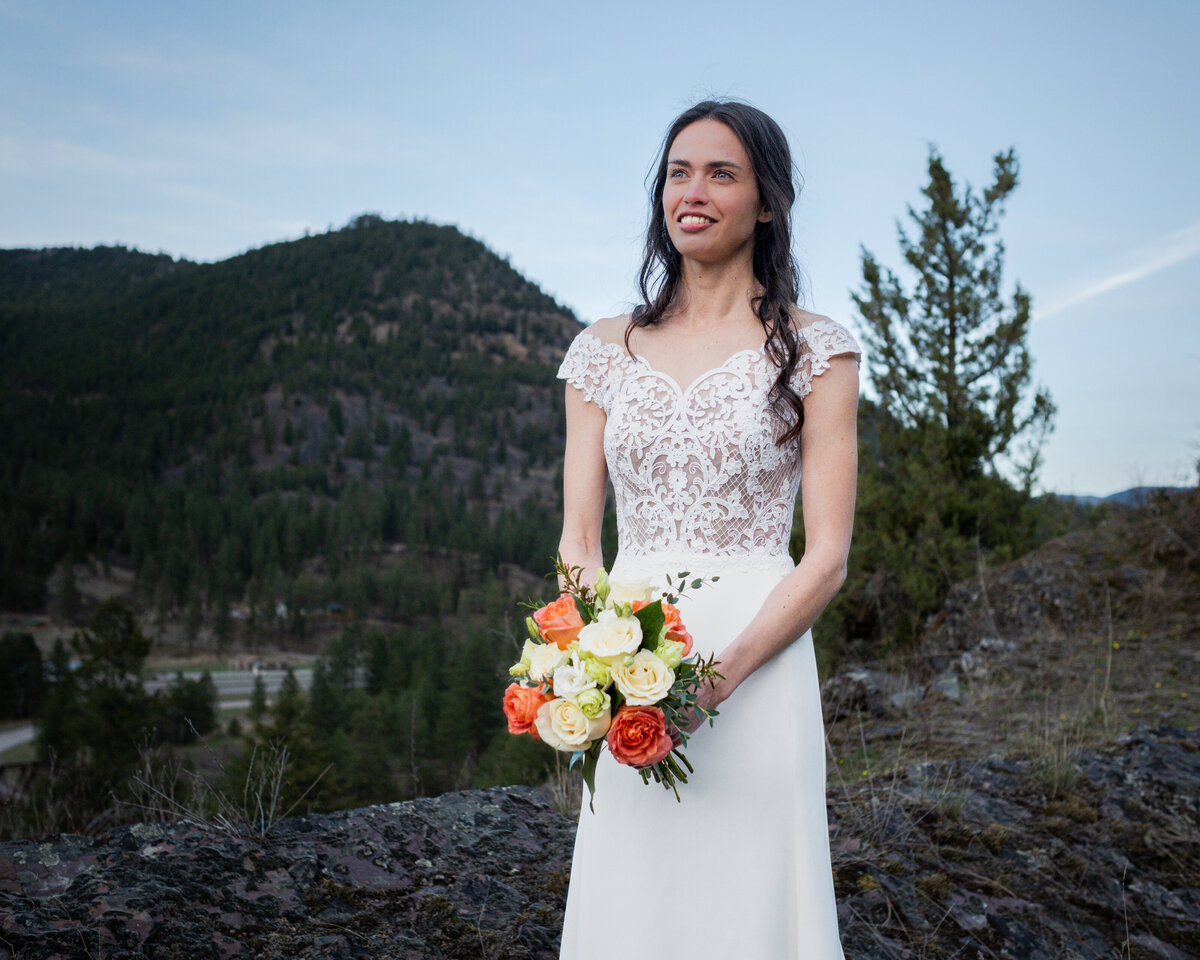 elopement - bride in white dress - brunette  in white dress holding flowers - flowers - mountain bride