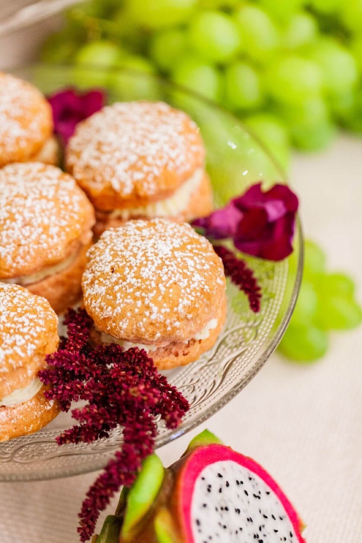 Sugar topped cream puffs on glass plate