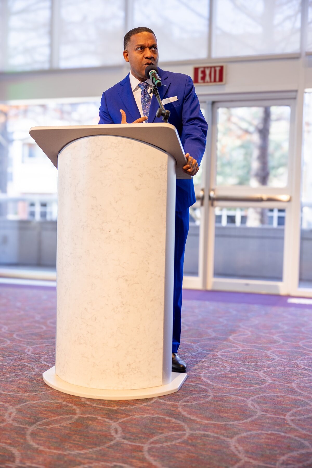 a man speaking at an event in Dallas TX