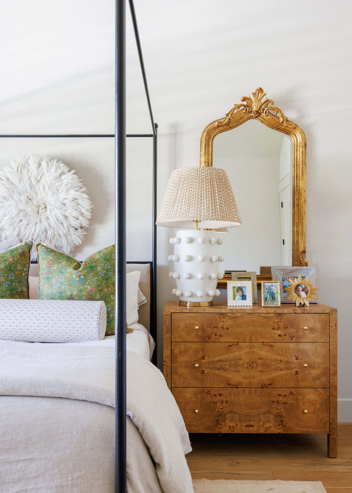 oyster creek studios aryns home canopy bed with white bedspread and green pillows next to a wooden bedside table