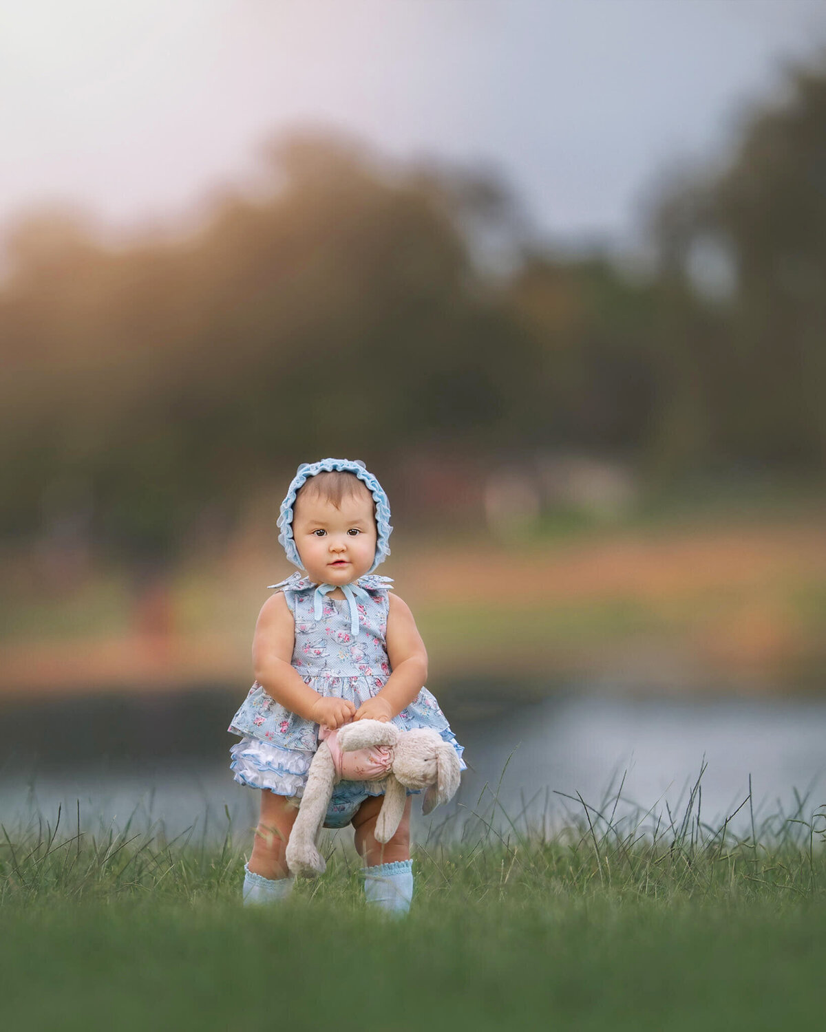 Little girl holding her bunny teddy at Lake Balboa Park by Los Angeles Children's photographer