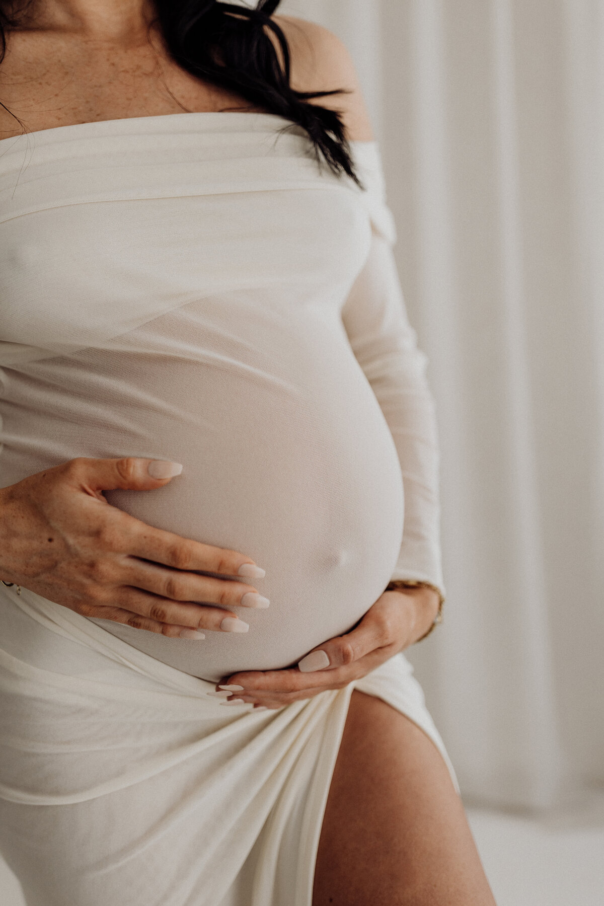 A close up image of a pregnant belly taken during a maternity photoshoot in lucy janes maternity  studio