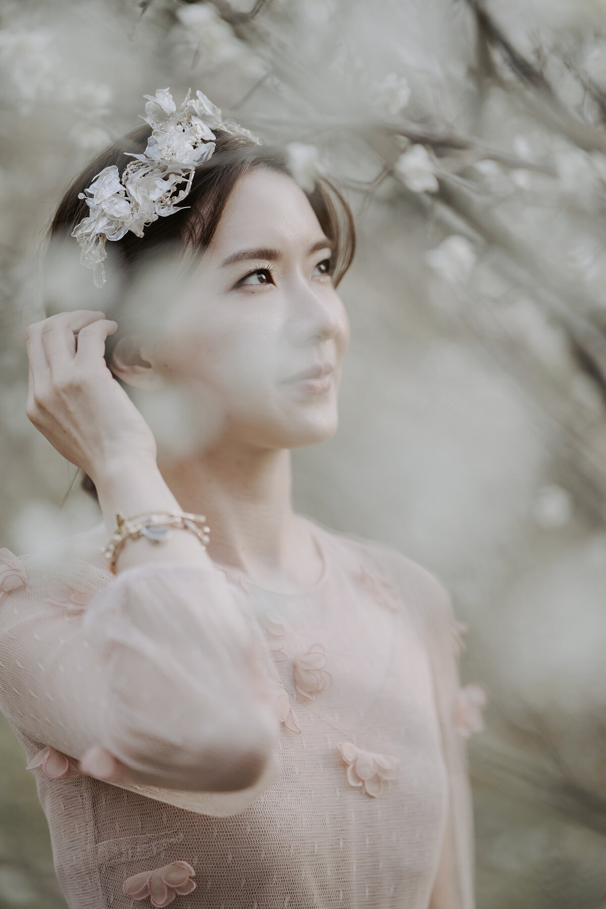 A bride wearing a flower head piece and pink dress