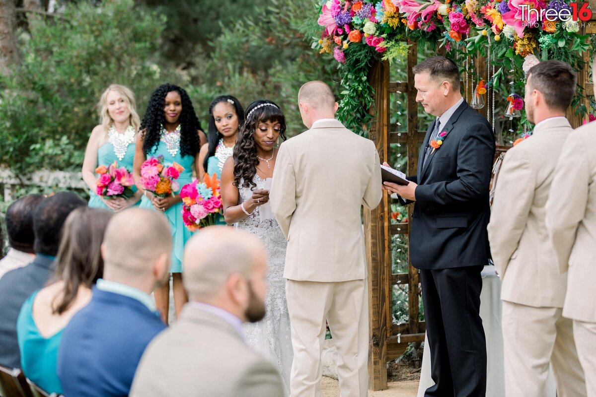 Bride and Groom share their vows to each other at the altar