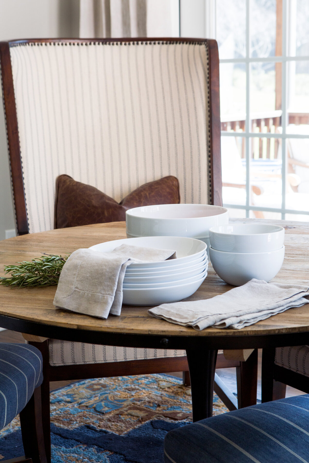 Stylish dining table in Lake Norman, NC, with soft linens, elegant tableware, and warm-toned decor.