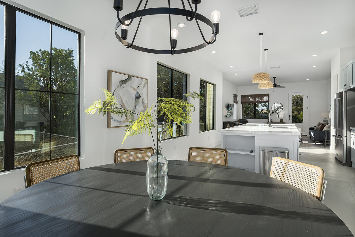 circular dining table with farmhouse light in open kitchen