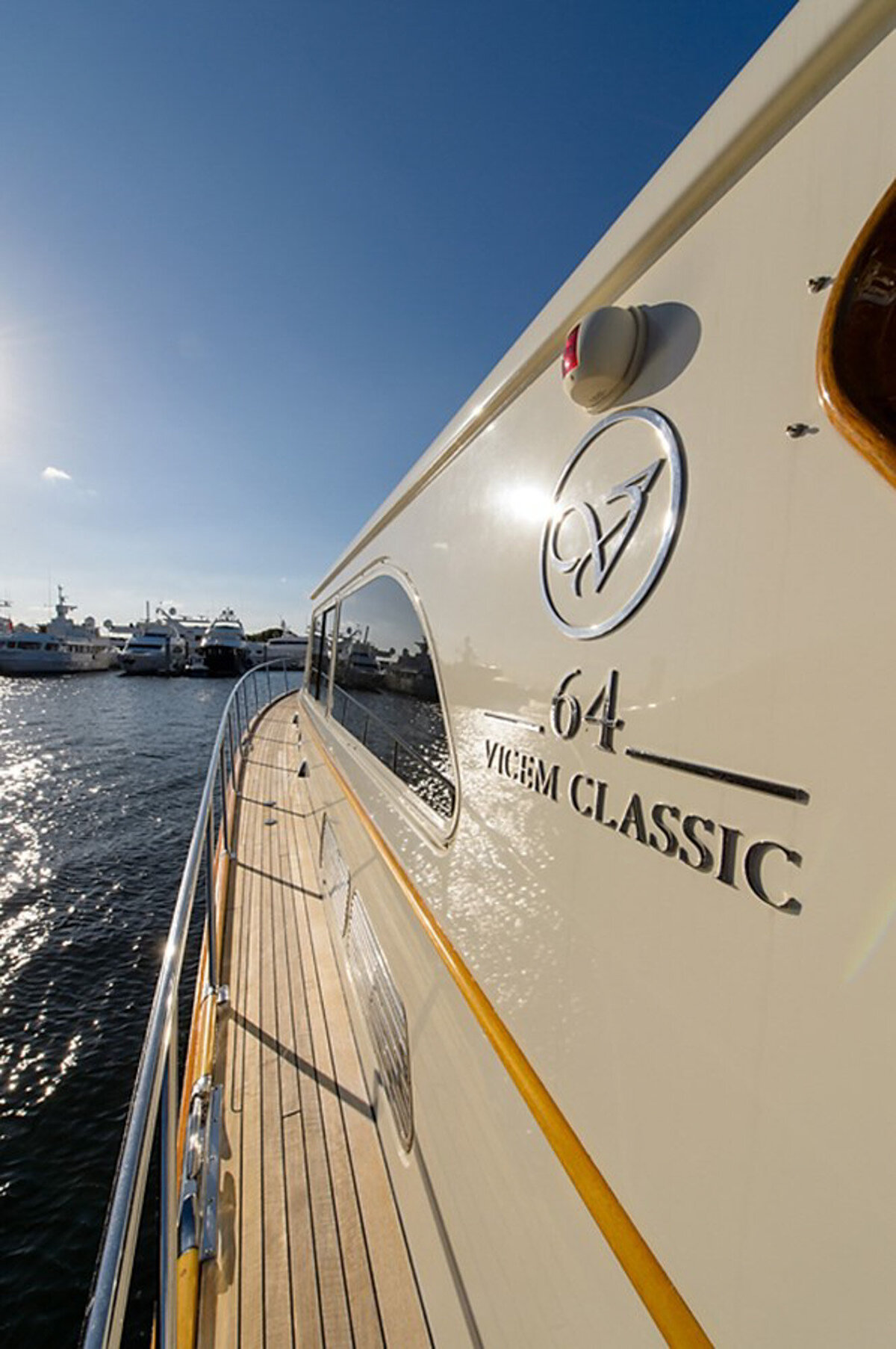 An angled view of a yacht's deck with the model name "Vicem Classic 64" displayed on the side