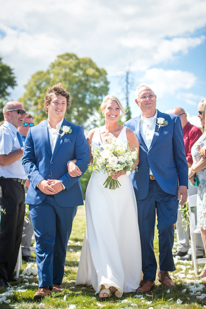 Bride walking down the isle with her son and father Union Bluff Meeting House York Beach Maine