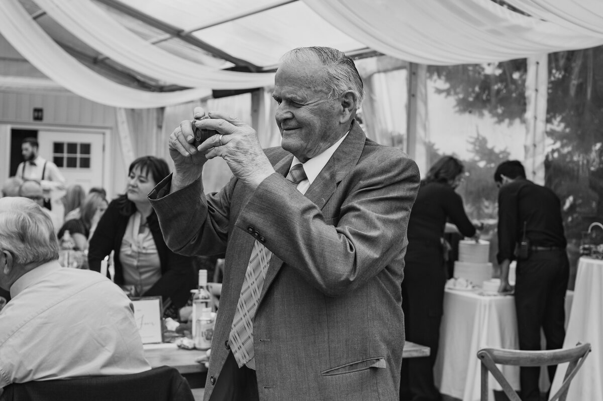 Grandpa taking cell phone phot at receptions