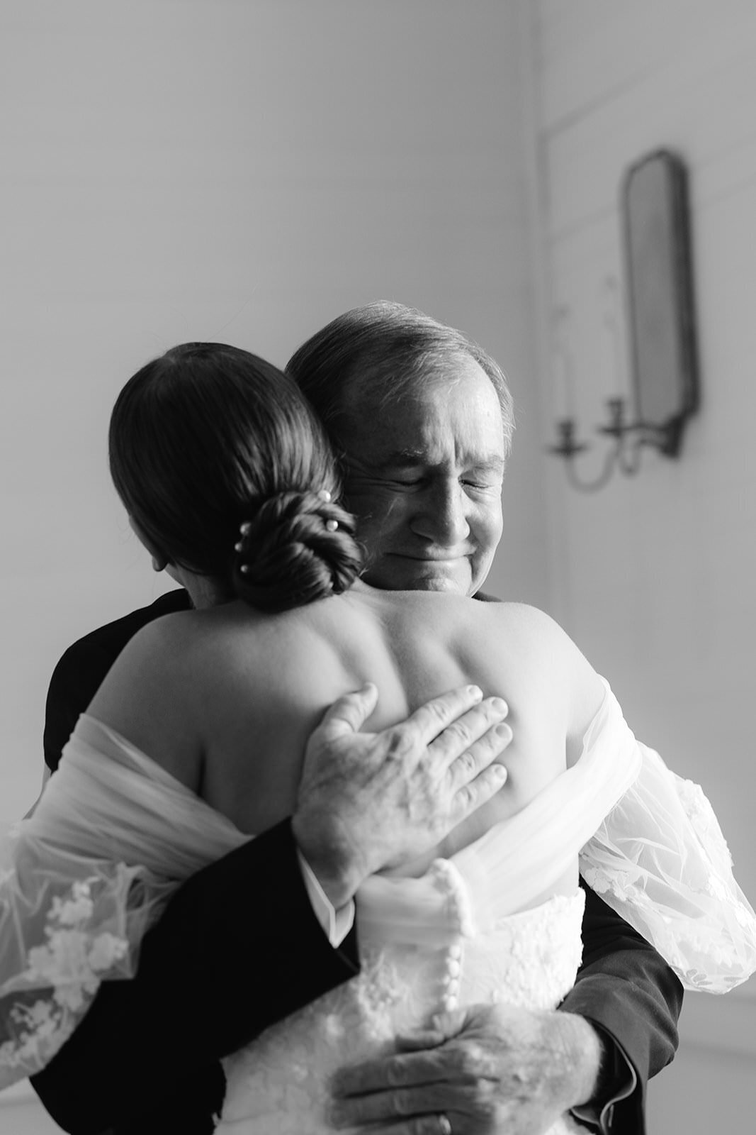 Emotional father-of-the-bride hugs his daughter on her wedding day